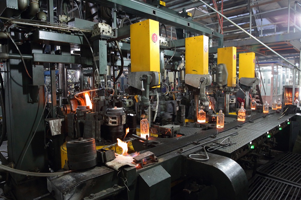 IS forming machines shaping hot super-flint spirits bottles at the Heze factory