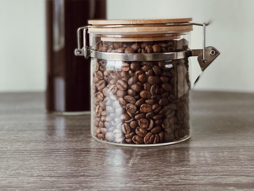 Clear glass coffee jar of roasted beans with a clamp lid