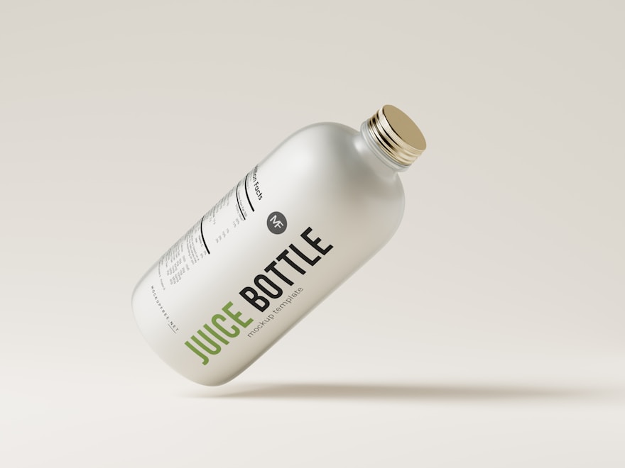 Clear glass juice bottle with a metal cap on a soft grey backdrop
