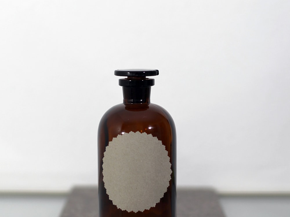 Amber glass apothecary bottle with a blank label, ready for custom artwork